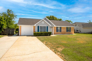 Updated 3 bedroom 2 bath home with screened porch and large fenced back yard with new 2022 roof, new diagonal pattern tile throughout living area, new wood design plank in bedrooms and tiled kitchen and baths
